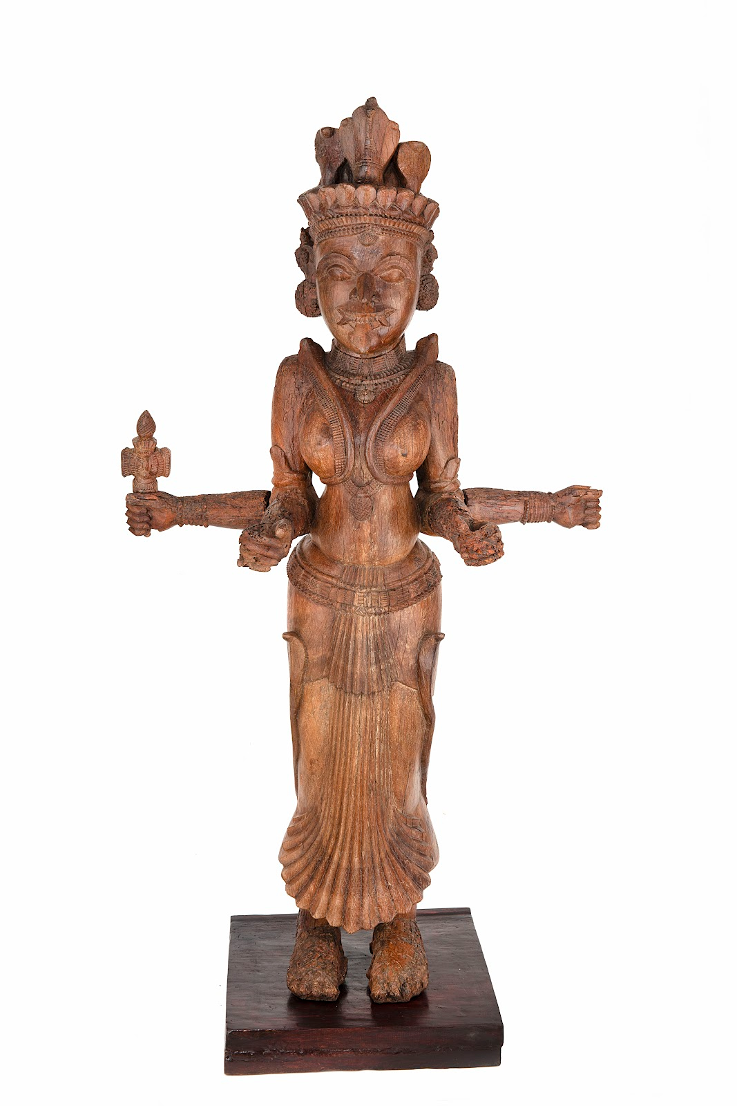 This wooden, life-size daiva sculpture of Bhagavati, the Mother Goddess. She has four arms, holds her tongue out and has traces of kumkum or vermillion powder on her.